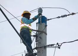 professional electrician installing the pin insulators to overhead utility poles.