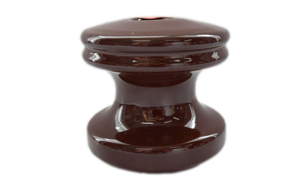 Shackle insulators isolate conductors from poles