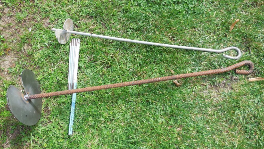 Earth anchors transfer tensile loads from surface equipment